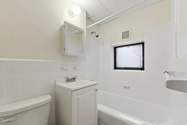 a bathroom with a toilet a sink and bathtub