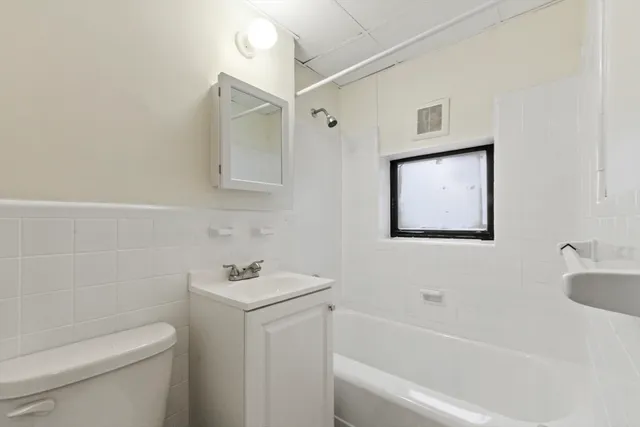 a bathroom with a toilet a sink and bathtub