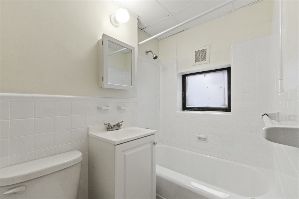 38-40 Cedar Street, Unit 335 Worcester, MA 01609 - Photo 14 of 21 a bathroom with a sink toilet and vanity