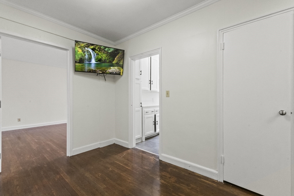 38-40 Cedar Street, Unit 335 Worcester, MA 01609 - Photo 8 of 21 a view of an empty room with wooden floor and a window