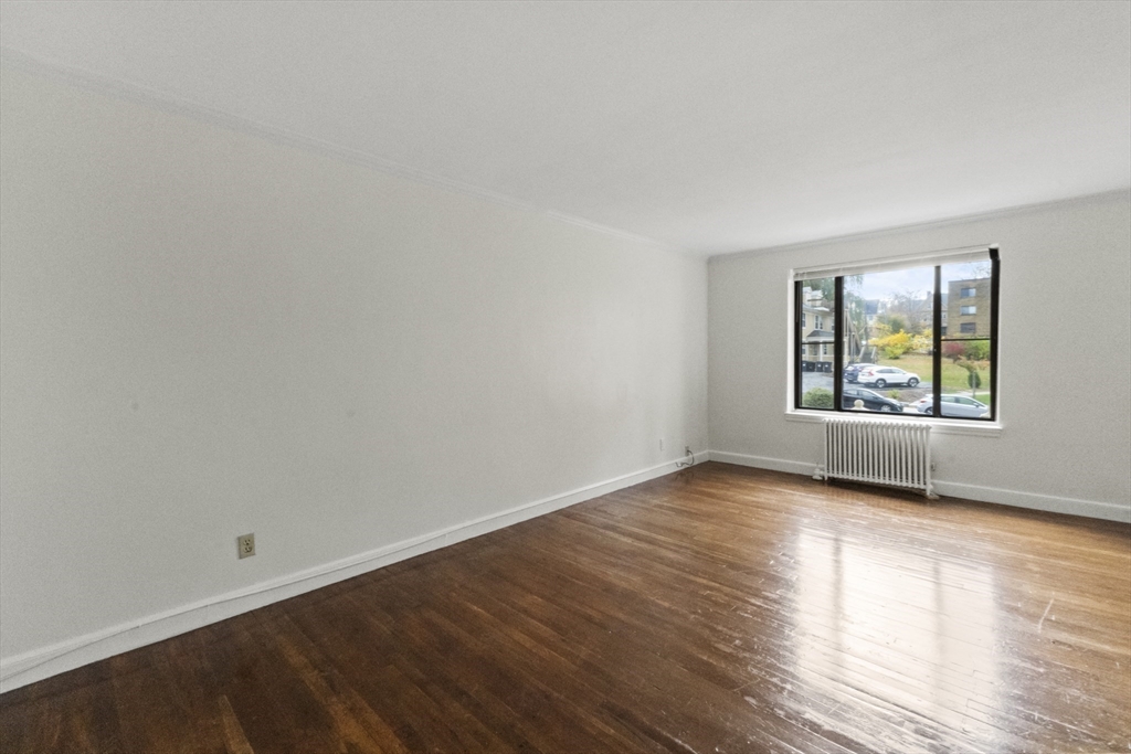 38-40 Cedar Street, Unit 335 Worcester, MA 01609 - Photo 10 of 21 wooden floor in an empty room with a window