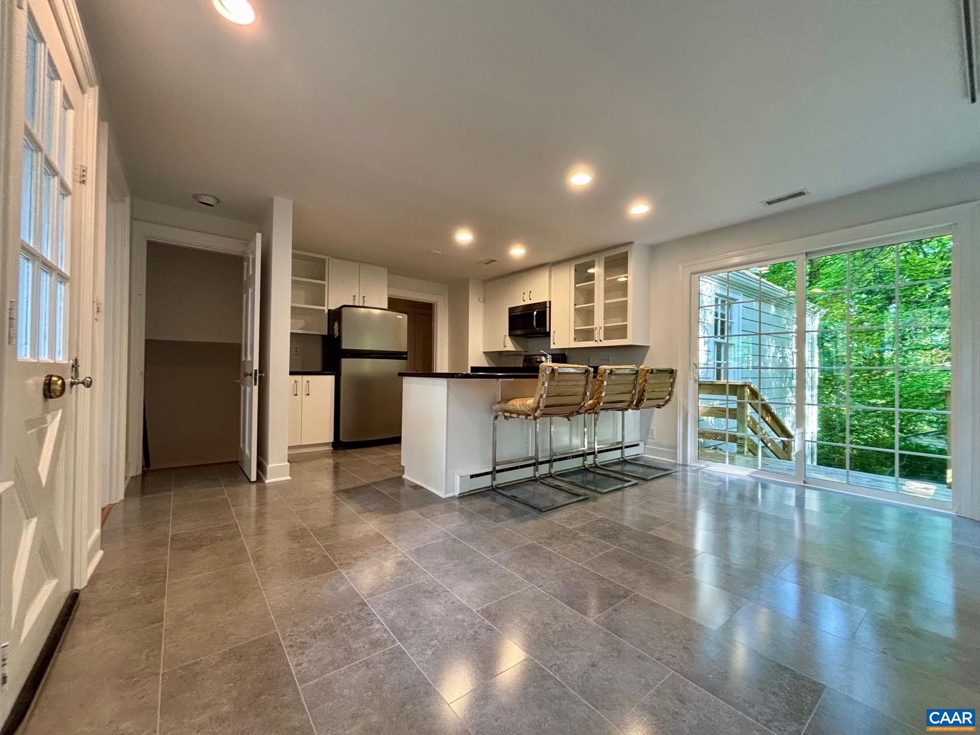 1426 Dairy Road Charlottesville, VA 22903 - Photo 12 of 48 a view of a kitchen with refrigerator microwave and furniture
