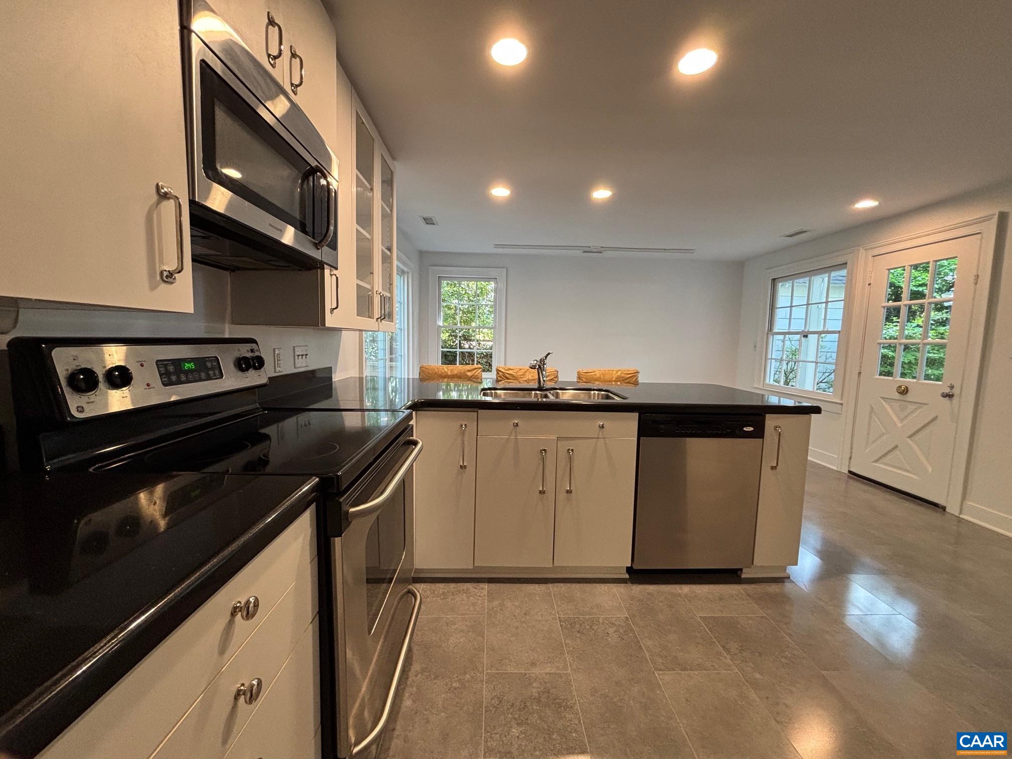 1426 Dairy Road Charlottesville, VA 22903 - Photo 15 of 48 a kitchen with a sink stove and cabinets
