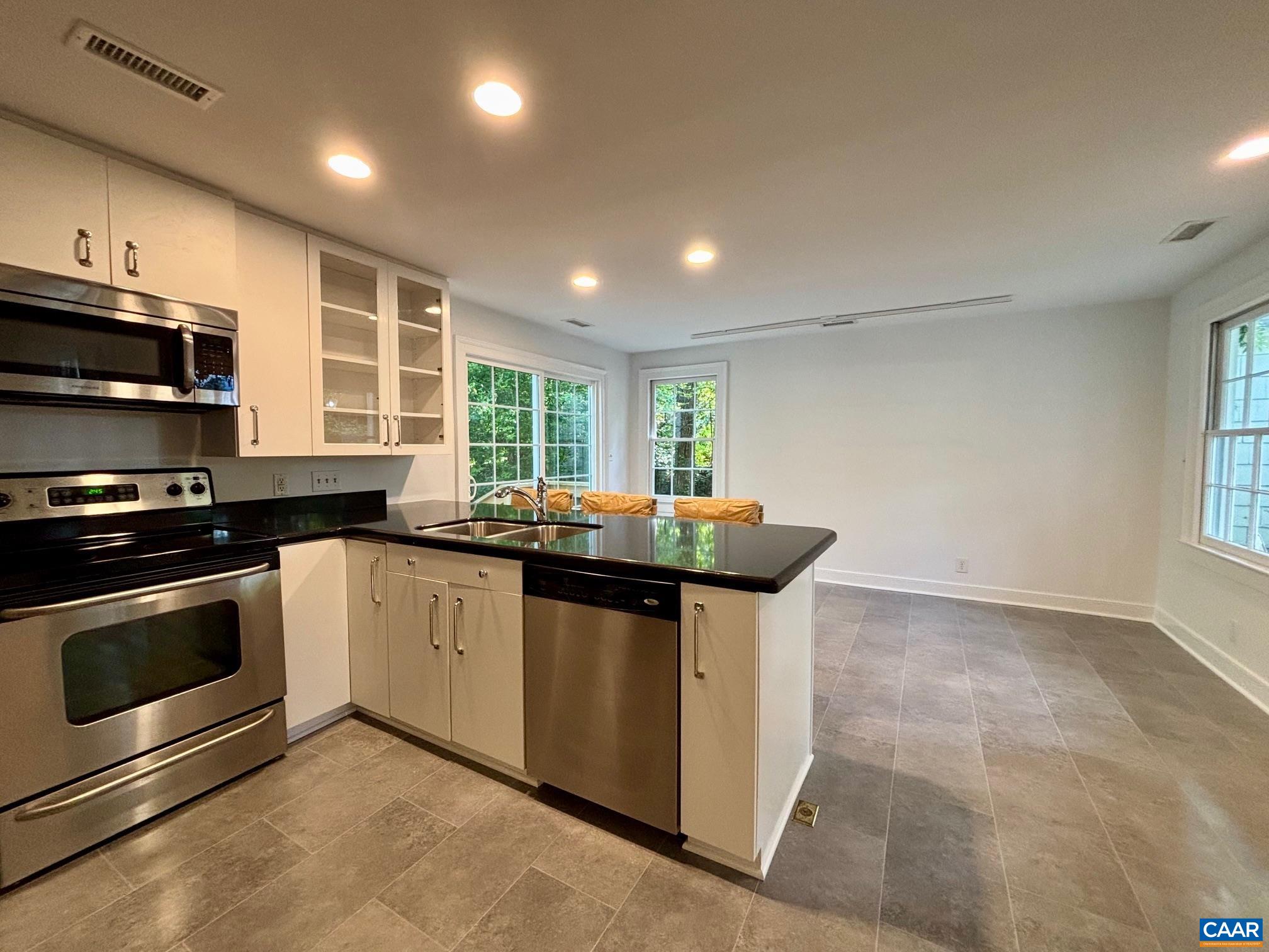 1426 Dairy Road Charlottesville, VA 22903 - Photo 16 of 48 a kitchen with stainless steel appliances granite countertop a stove and a sink