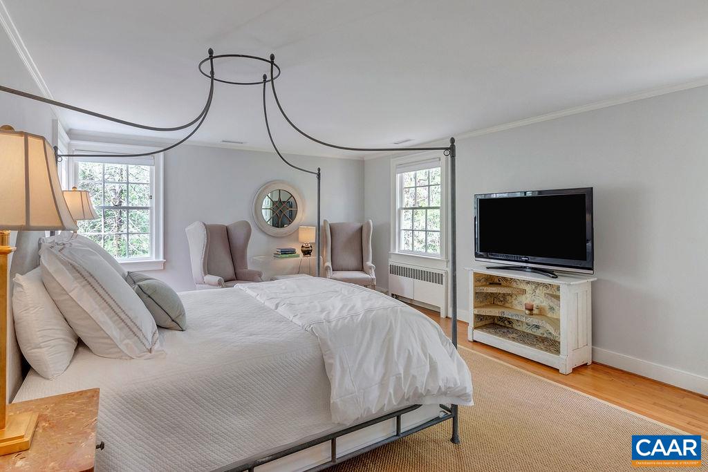 1426 Dairy Road Charlottesville, VA 22903 - Photo 18 of 48 a bedroom with a bed and a flat screen tv in it
