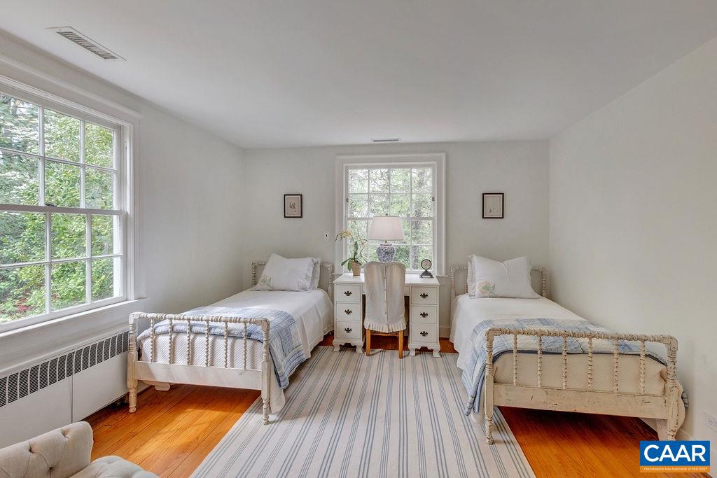 1426 Dairy Road Charlottesville, VA 22903 - Photo 20 of 48 a bedroom with a bed and wooden floor