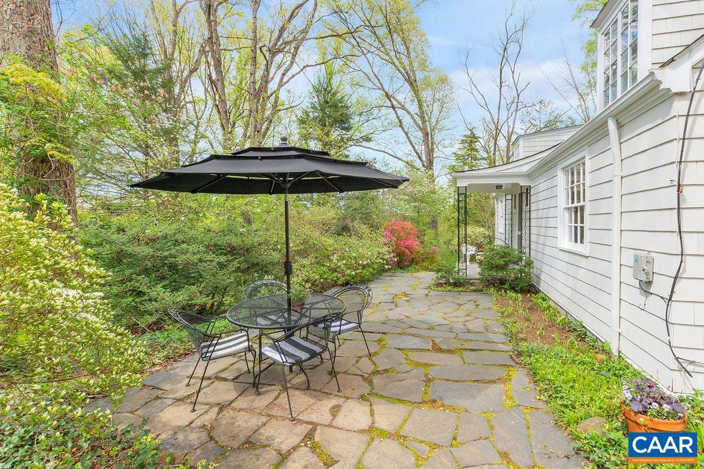 1426 Dairy Road Charlottesville, VA 22903 - Photo 34 of 48 a view of a pathway with a table and chairs under an umbrella