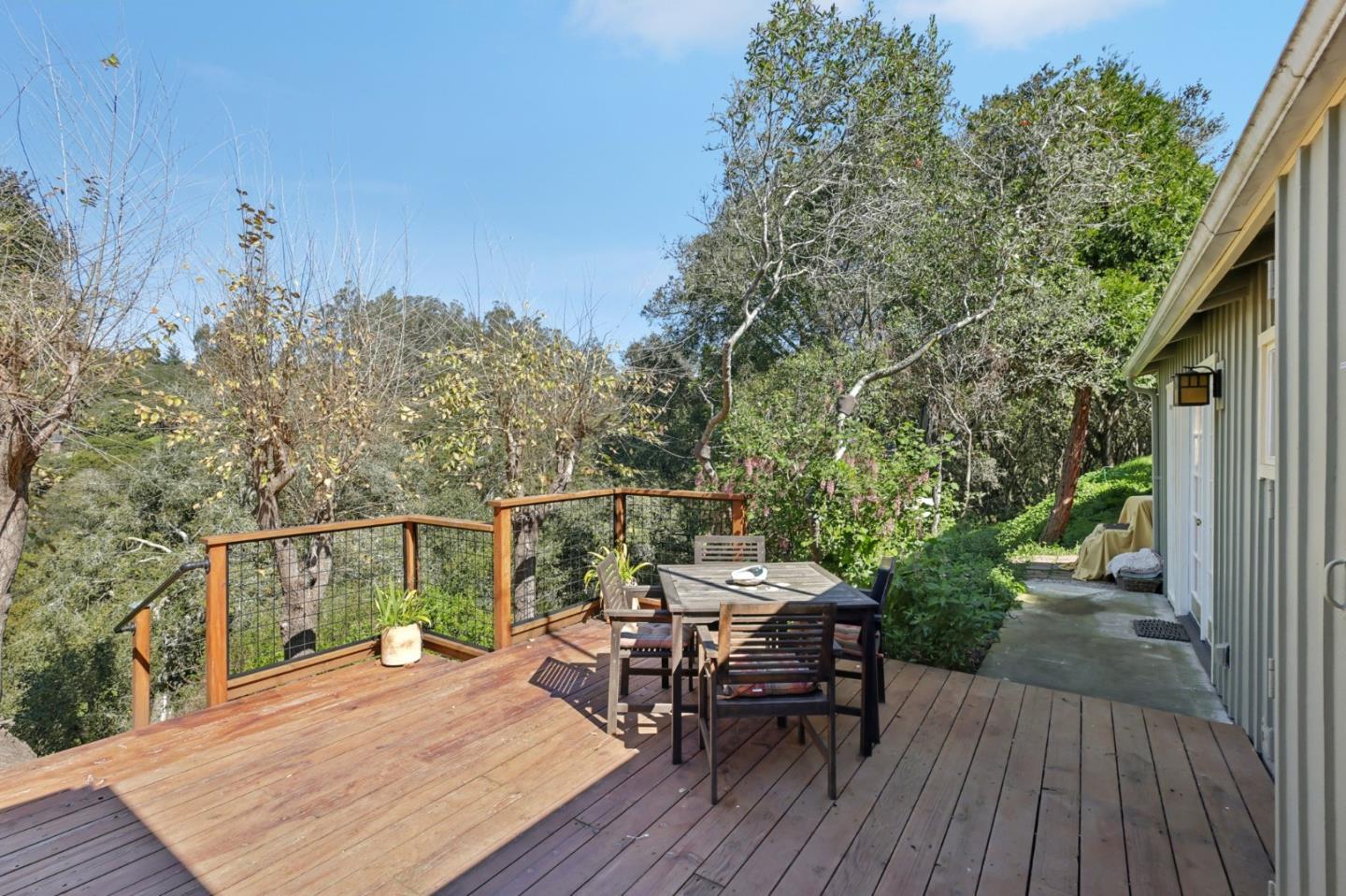 122 Strawberry Road Watsonville, CA 95076 - Photo 31 of 57 a view of a roof deck with table and chairs with wooden floor and fence