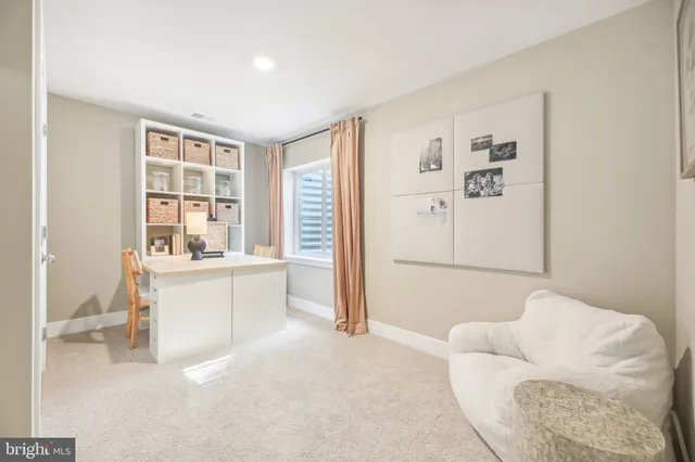 a living room with furniture and white walls