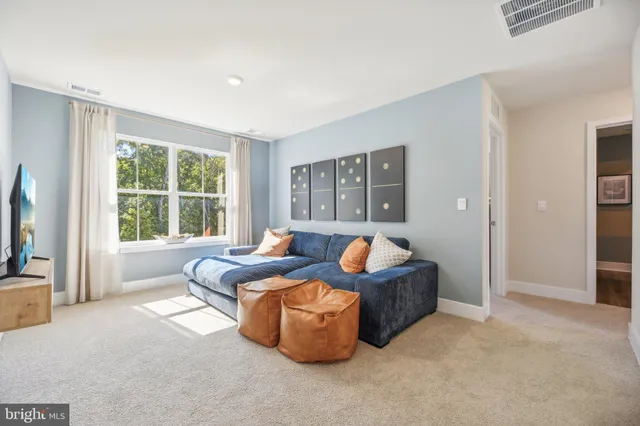 a living room with furniture and large windows