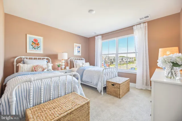 a bedroom with furniture and a large window