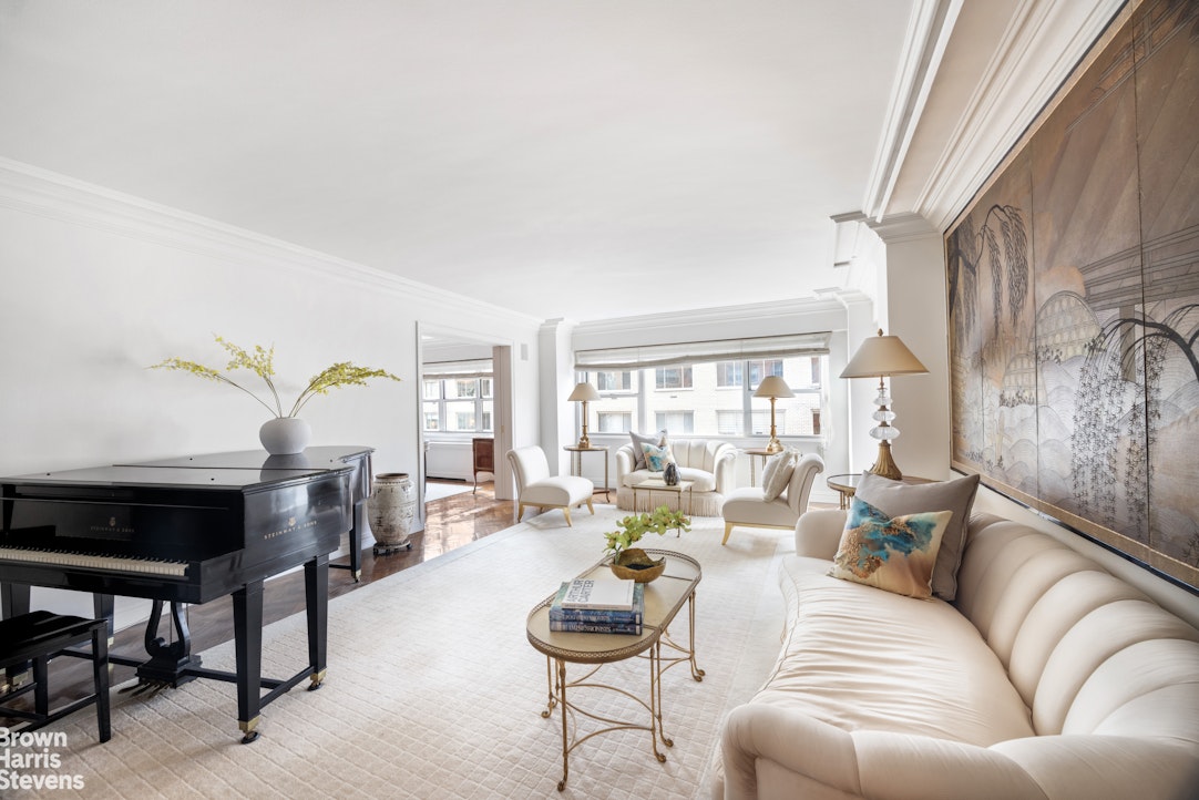 27 East 65th Street, Unit 9DE Manhattan, NY 10065 - Photo 1 of 14 a living room with furniture and a large window