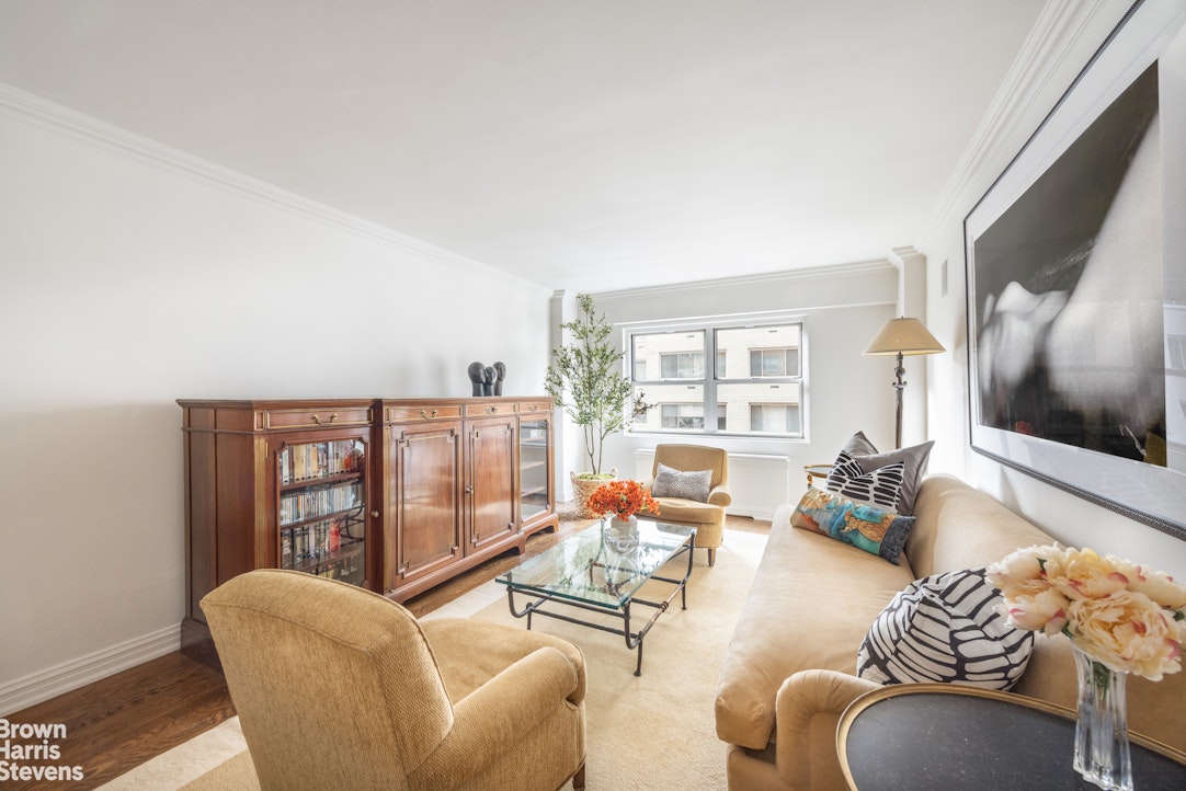 27 East 65th Street, Unit 9DE Manhattan, NY 10065 - Photo 10 of 14 a living room with furniture and a floor to ceiling window