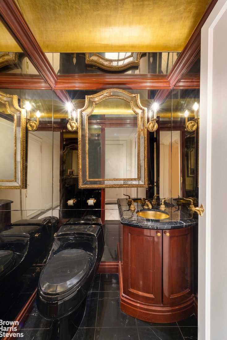 27 East 65th Street, Unit 9DE Manhattan, NY 10065 - Photo 11 of 14 a bathroom with a sink and a mirror