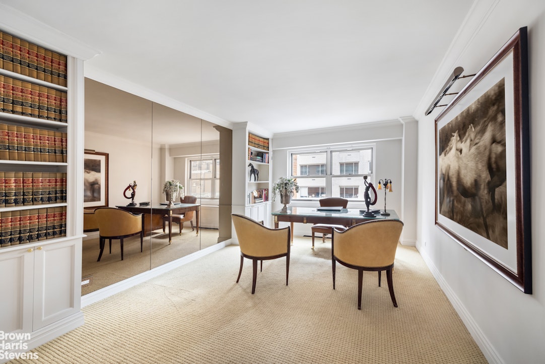 27 East 65th Street, Unit 9DE Manhattan, NY 10065 - Photo 8 of 14 a living room with furniture a rug and a window