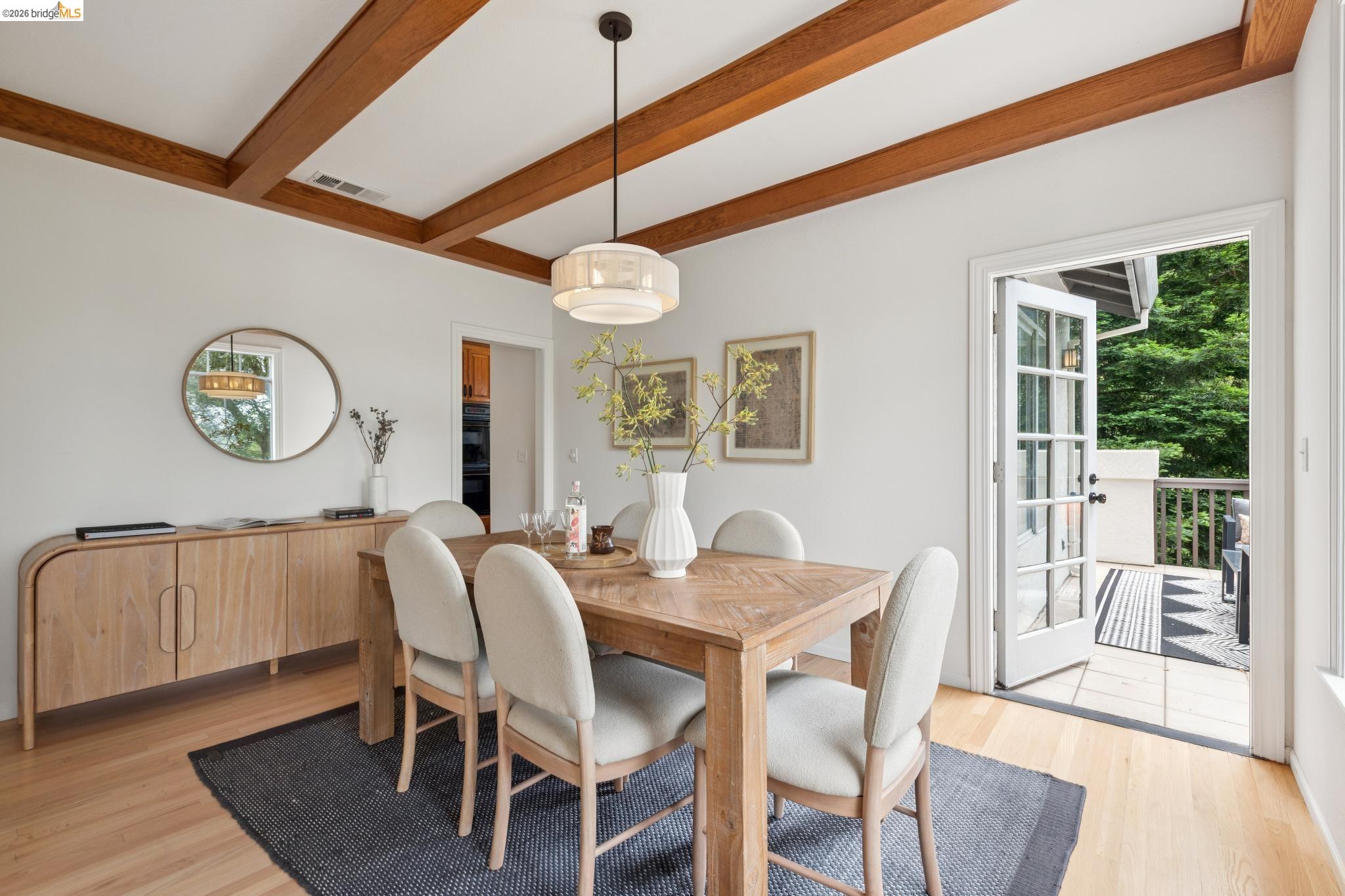 1325 Drury Road Berkeley, CA 94705 - Photo 18 of 71 Dining space featuring exposed wood ceiling beams, wood-finish flooring, and French doors opening to an outdoor patio