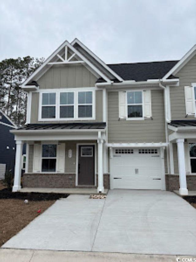 524 Ryegrass Way, Unit 22G Murrells Inlet, SC 29576 - Photo 1 of 14 Craftsman-style house featuring board and batten siding, covered porch, driveway, an attached garage, and brick siding