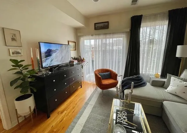 a kitchen with stainless steel appliances granite countertop a refrigerator a stove a sink a dining table and chairs