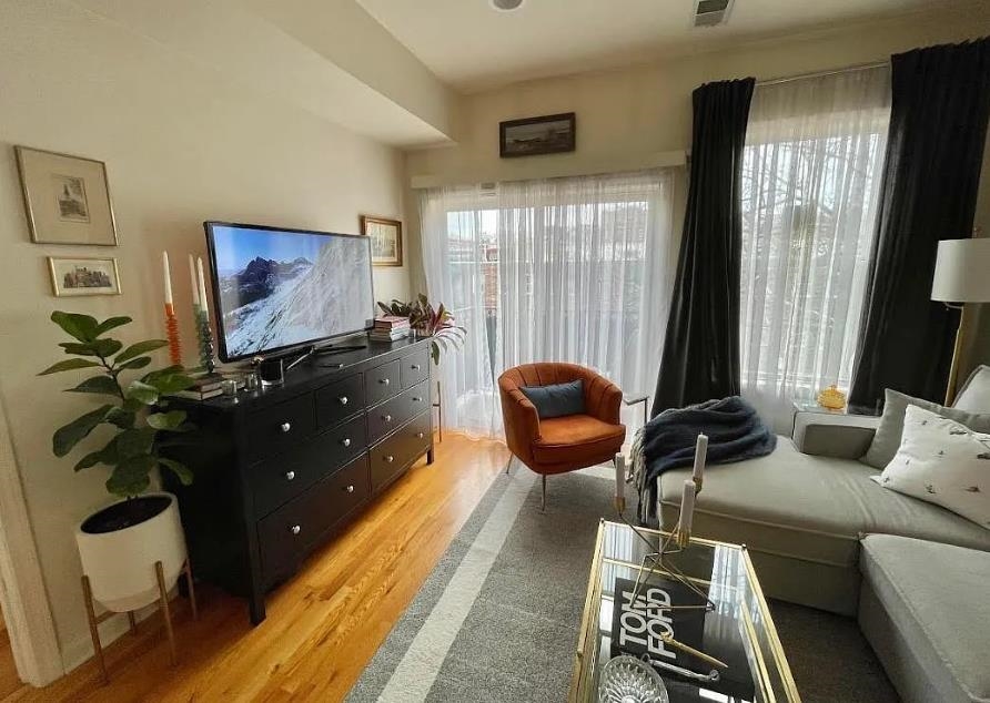 608 Jefferson Street, Unit 3 Hoboken, NJ 07030 - Photo 2 of 14 a living room with furniture and a flat screen tv