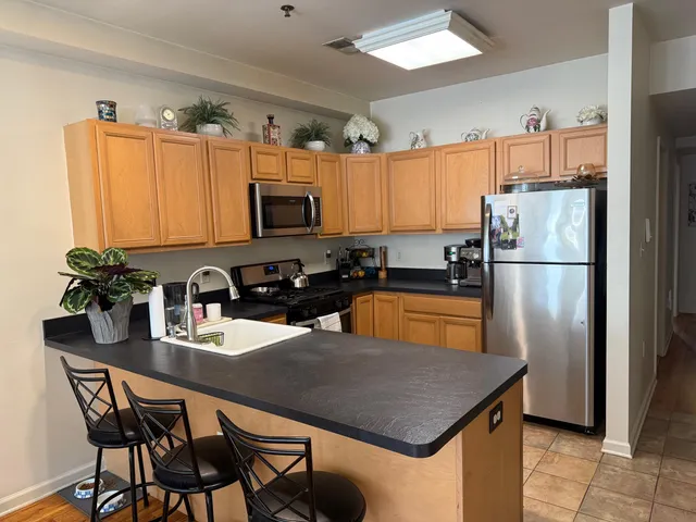 a kitchen with a refrigerator and a stove