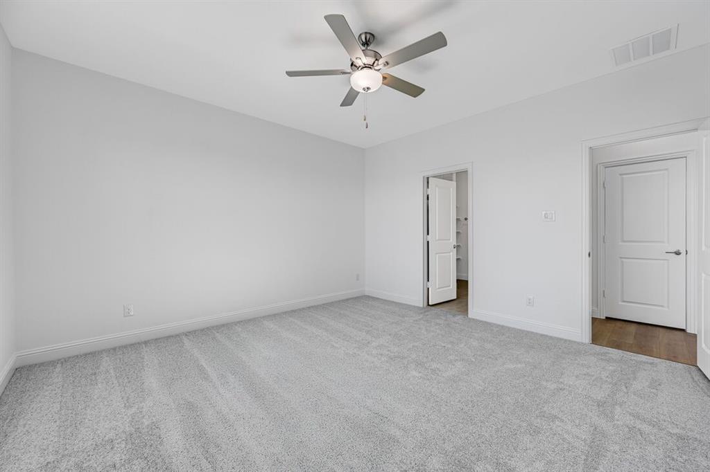 1429 Arciones Road Fort Worth, TX 76052 - Photo 11 of 39 a view of an empty room with a ceiling fan