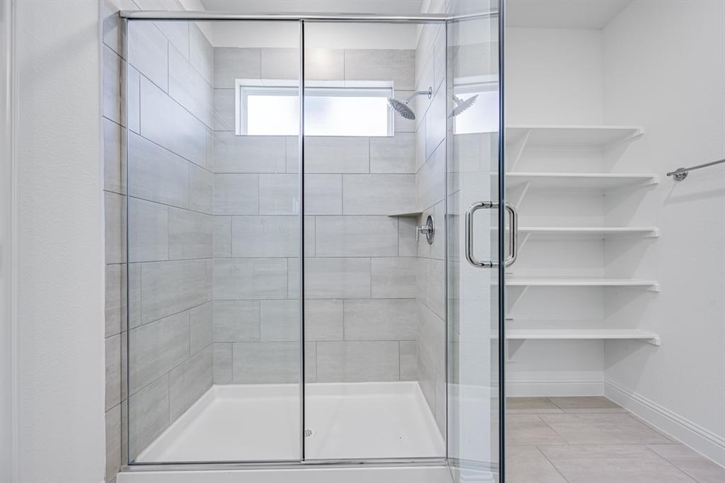 1429 Arciones Road Fort Worth, TX 76052 - Photo 12 of 39 a bathroom with a glass shower door