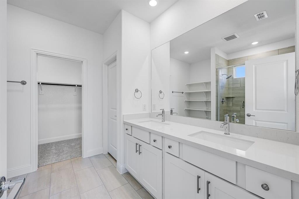 1429 Arciones Road Fort Worth, TX 76052 - Photo 13 of 39 a bathroom with a sink double vanity and a mirror