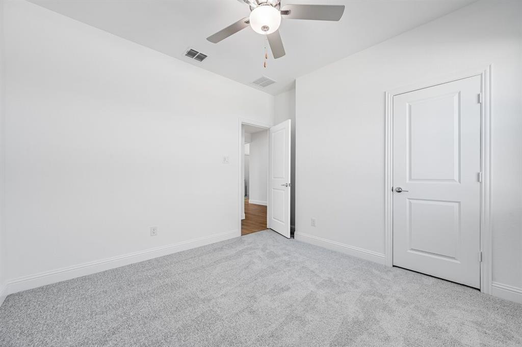 1429 Arciones Road Fort Worth, TX 76052 - Photo 21 of 39 an empty room with a ceiling fan and a window