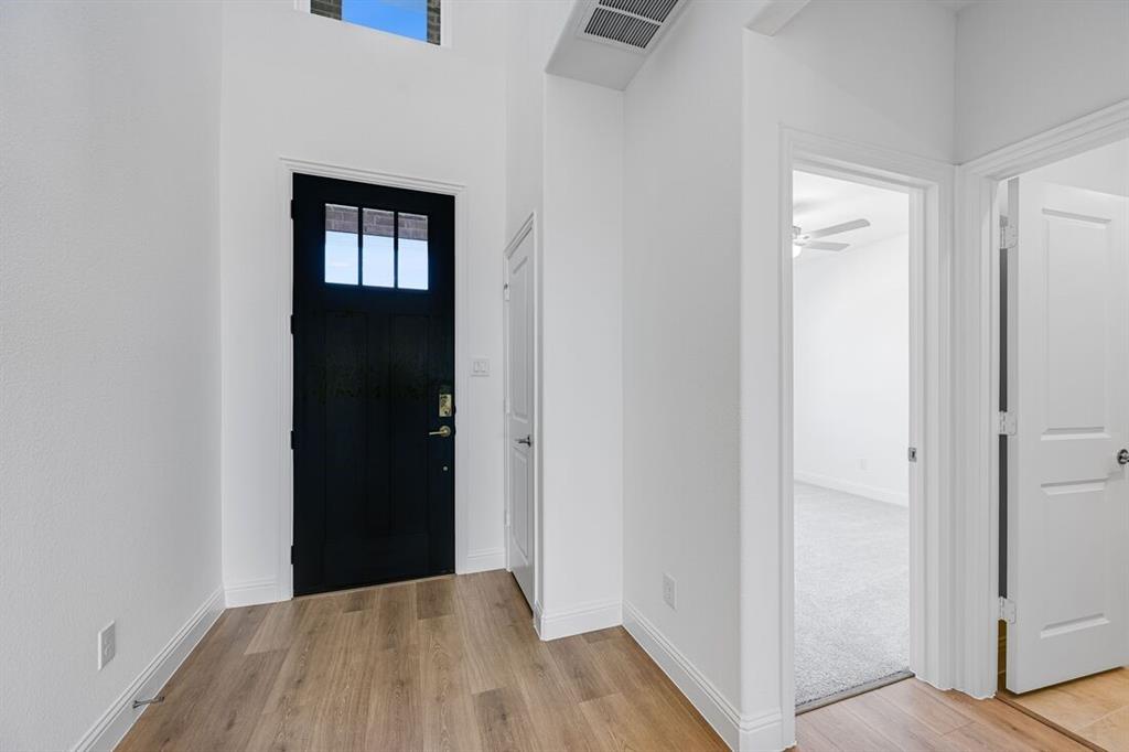 1429 Arciones Road Fort Worth, TX 76052 - Photo 26 of 39 a view of a hallway with wooden floor and a bathroom