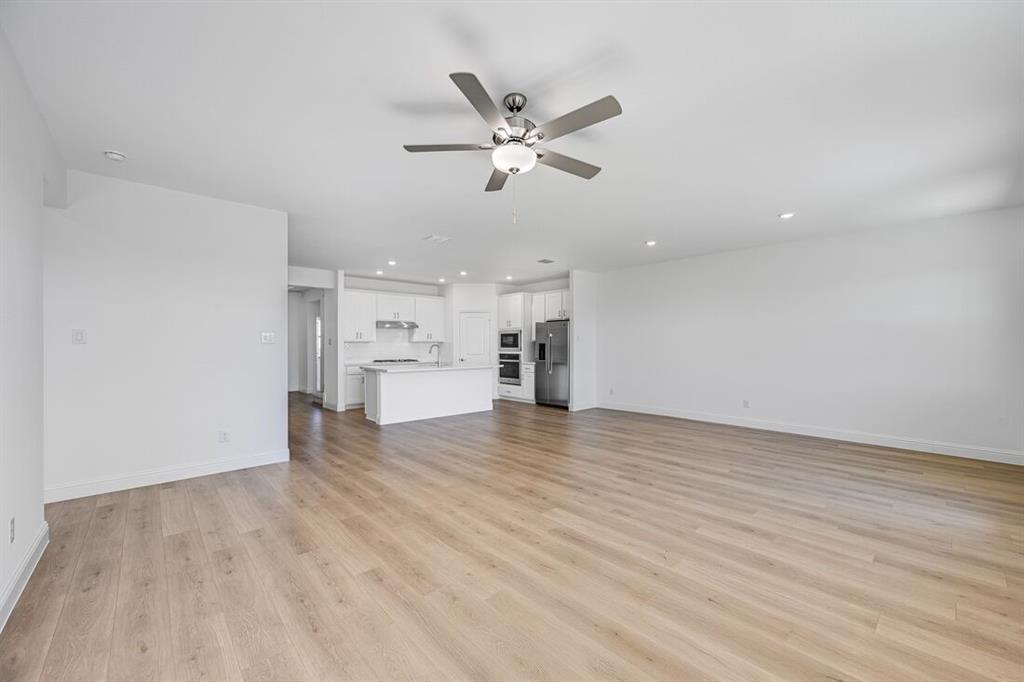 1429 Arciones Road Fort Worth, TX 76052 - Photo 6 of 39 a view of empty room with wooden floor and ceiling fan
