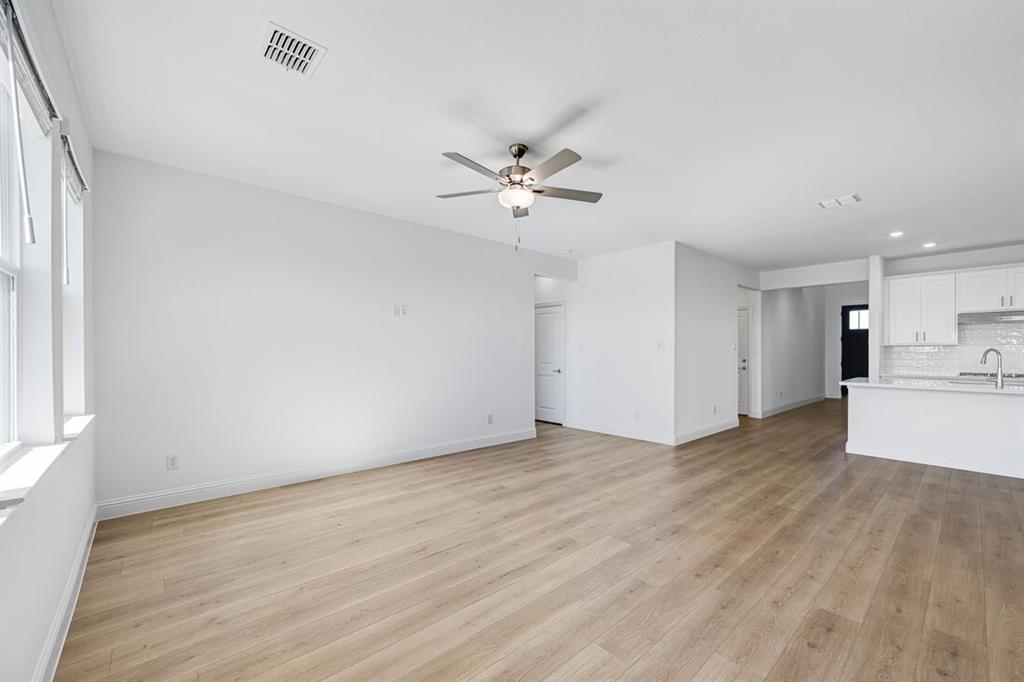 1429 Arciones Road Fort Worth, TX 76052 - Photo 7 of 39 wooden floor in an empty room with a window