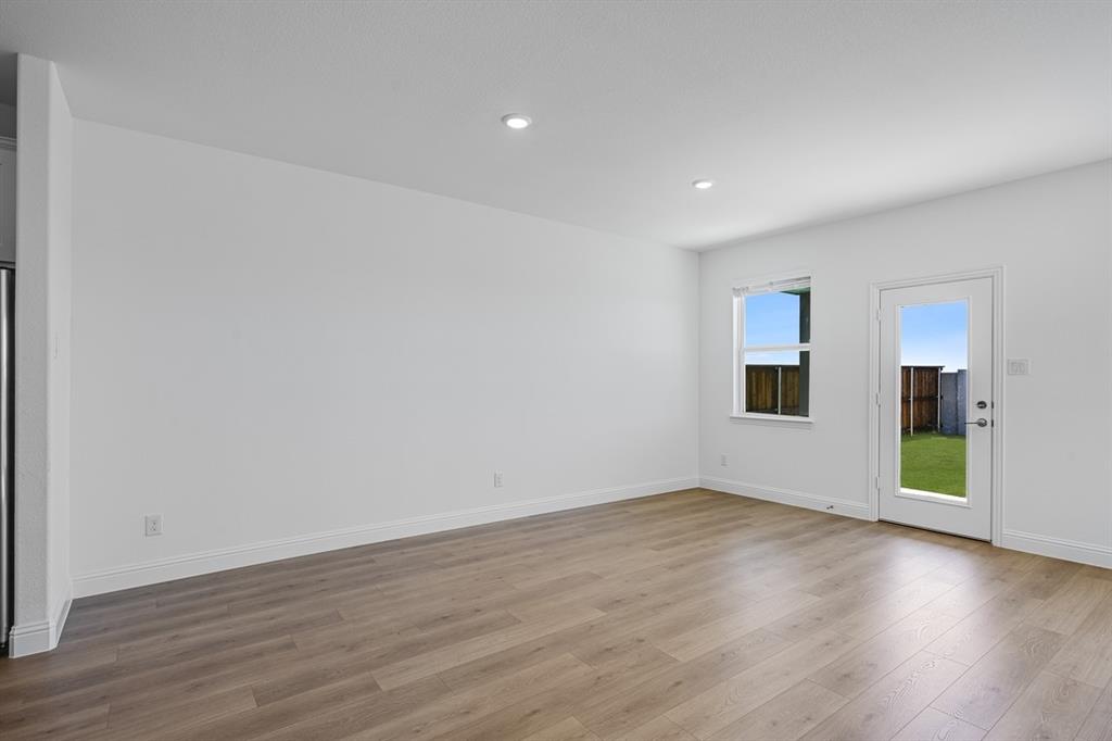 1429 Arciones Road Fort Worth, TX 76052 - Photo 9 of 39 a view of empty room with wooden floor and fan