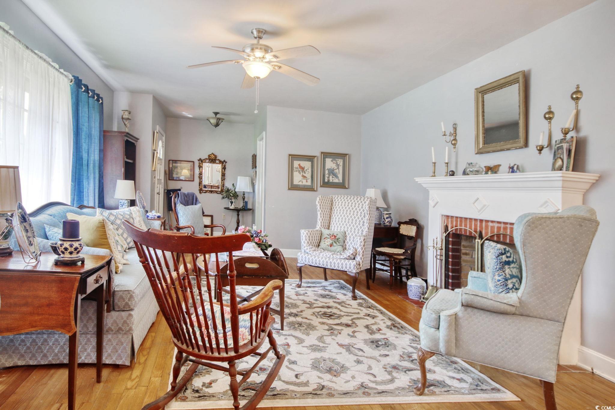 2004 Seitter Street Georgetown, SC 29440 - Photo 13 of 33 Living area featuring ceiling fan, wood finished floors, a fireplace, and baseboards