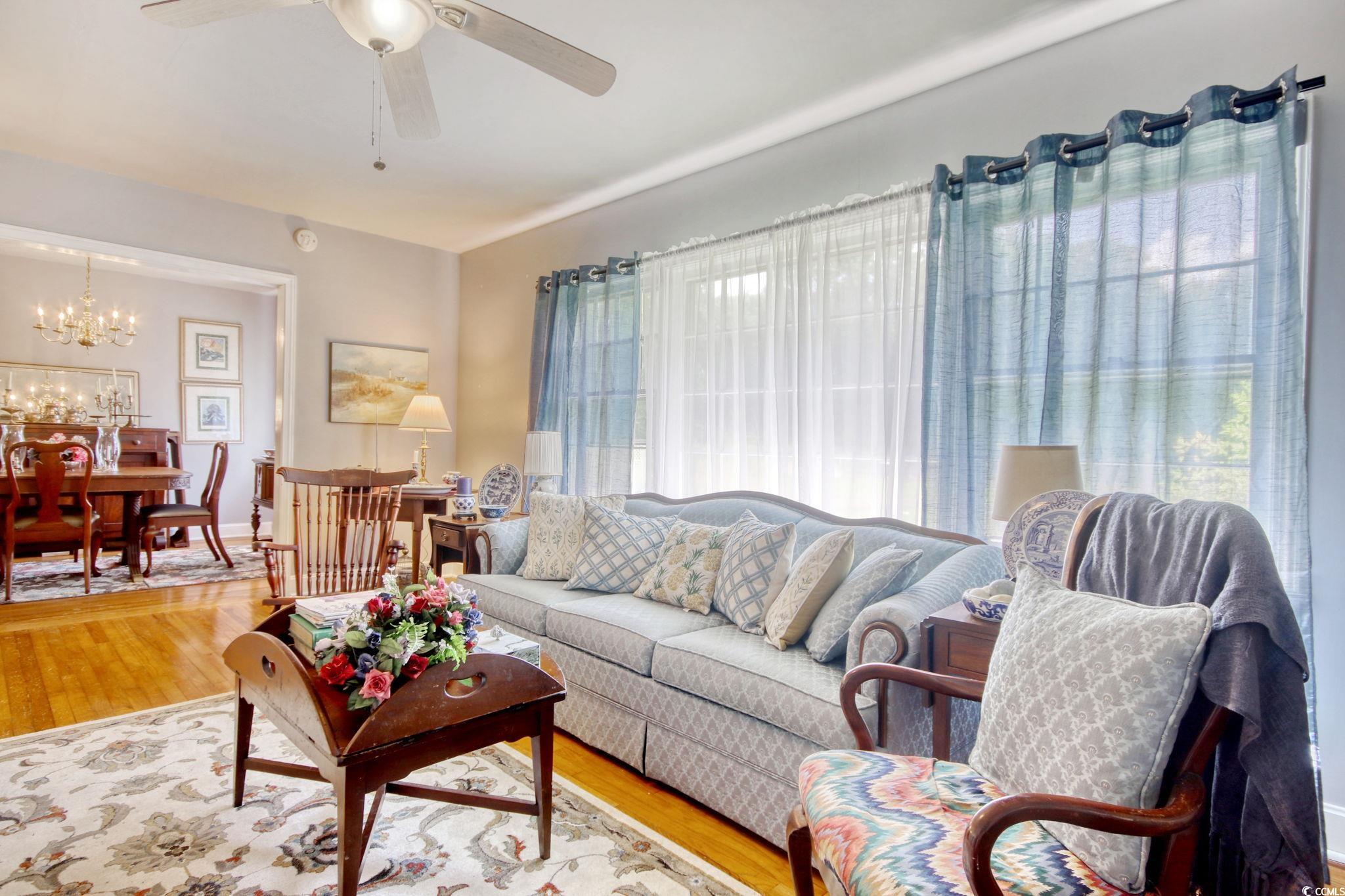 2004 Seitter Street Georgetown, SC 29440 - Photo 16 of 33 Living area with a chandelier, a ceiling fan, and wood finished floors