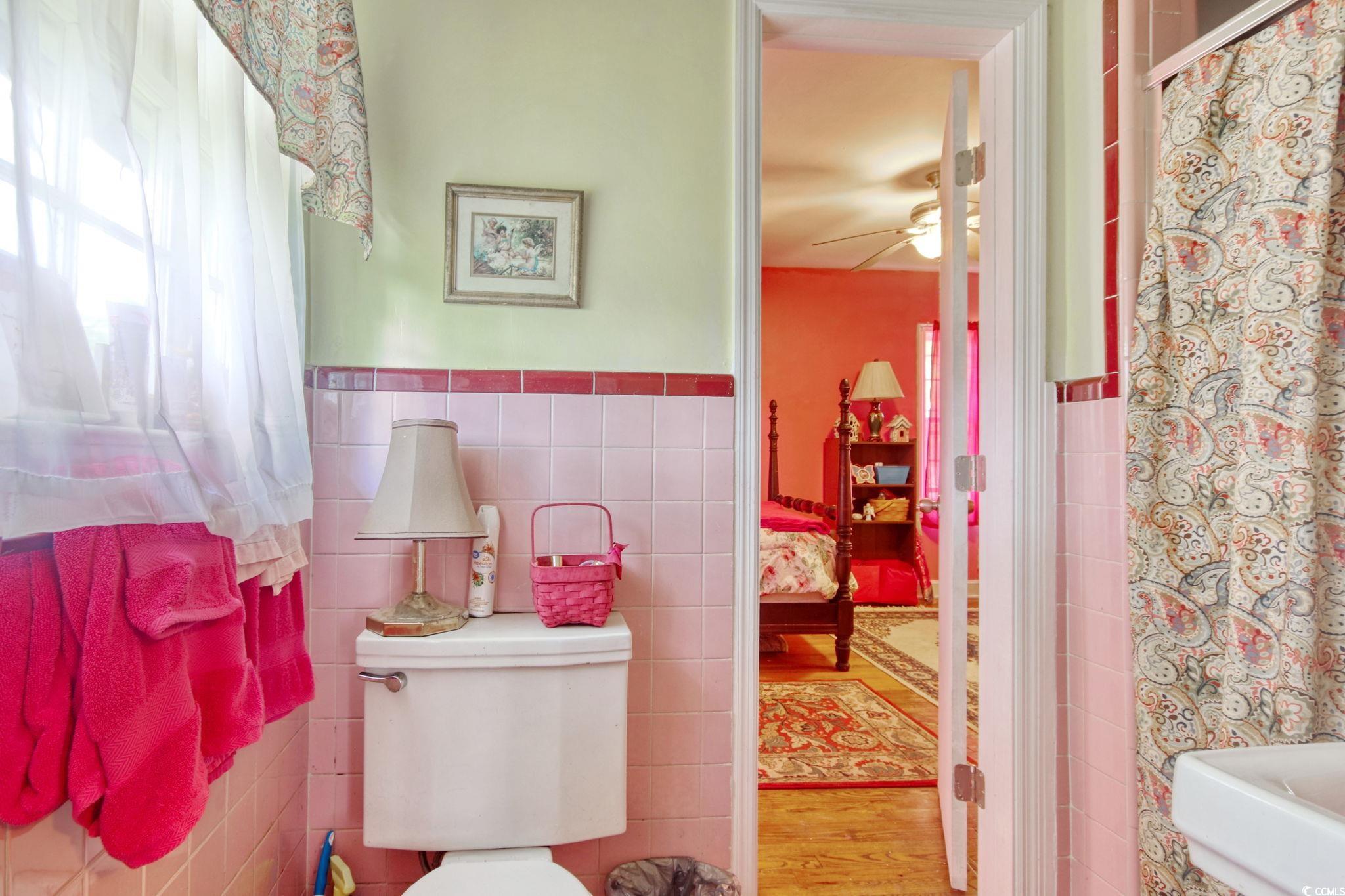 2004 Seitter Street Georgetown, SC 29440 - Photo 25 of 33 Full bathroom with tile walls, toilet, a ceiling fan, wainscoting, and wood finished floors