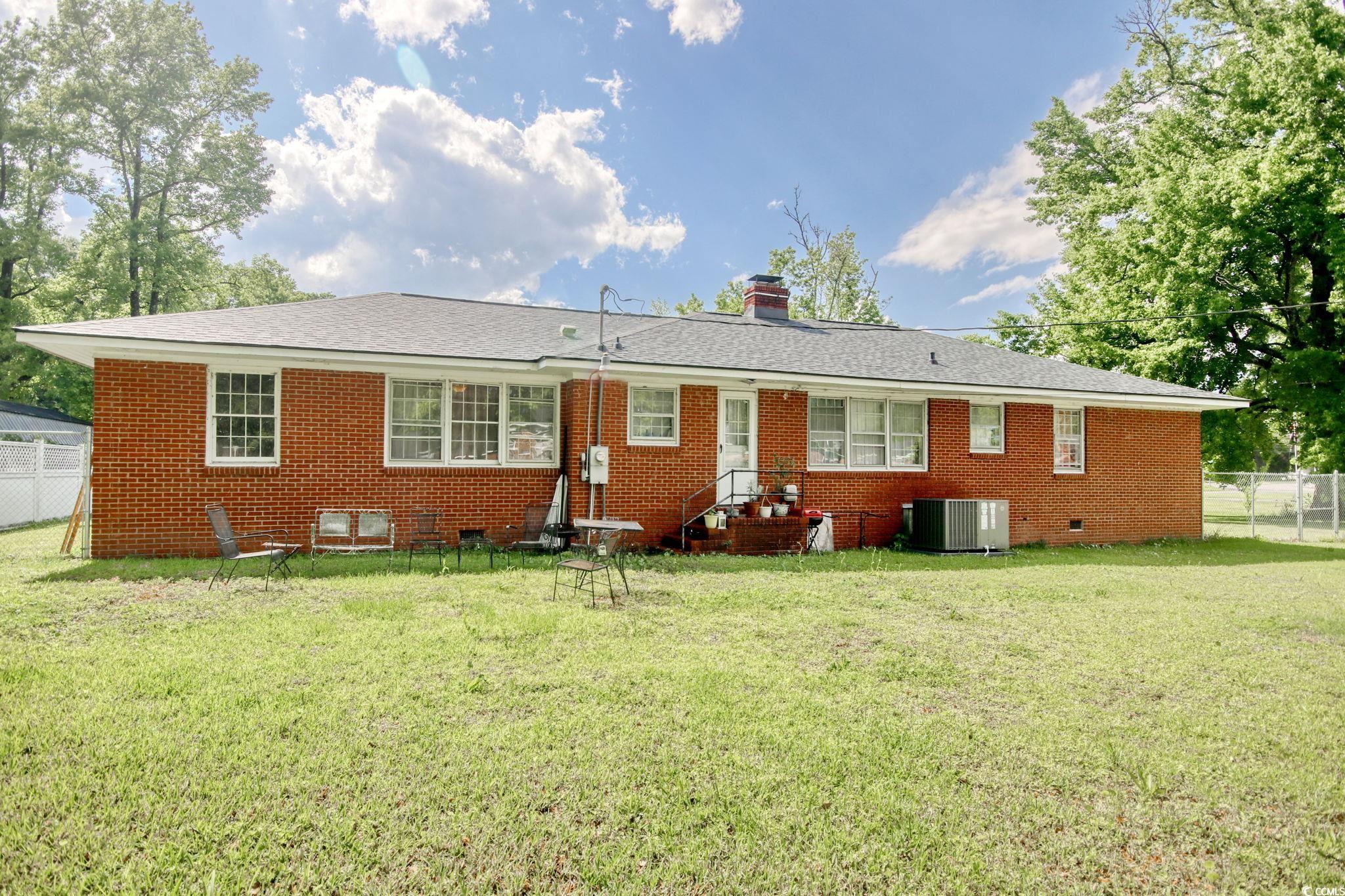 2004 Seitter Street Georgetown, SC 29440 - Photo 32 of 33 Rear view of house with brick siding, central air condition unit, and a chimney