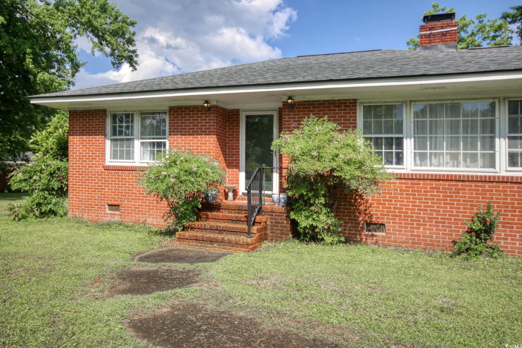 2004 Seitter Street Georgetown, SC 29440 - Photo 5 of 33 View of front of house featuring crawl space, brick siding, and a front lawn