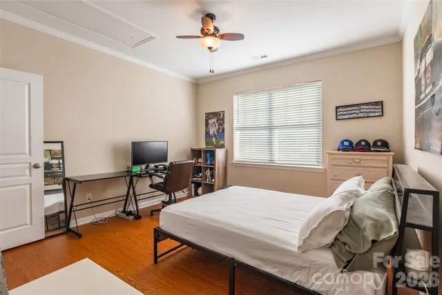 a bed sitting in a bedroom next to a window