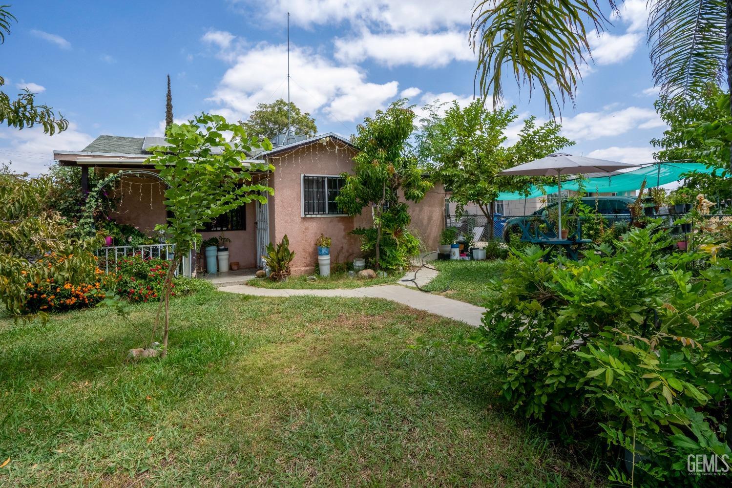 Undisclosed Address Bakersfield, CA 93305 - Photo 22 of 23 a view of a house with a yard and potted plants