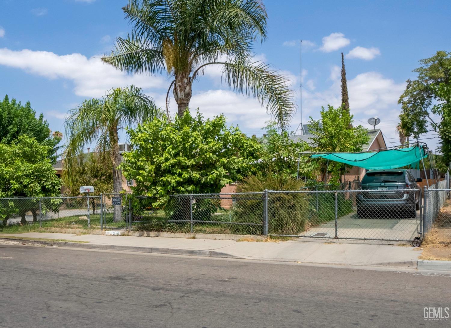 Undisclosed Address Bakersfield, CA 93305 - Photo 23 of 23 a backyard of a house with lots of palm trees