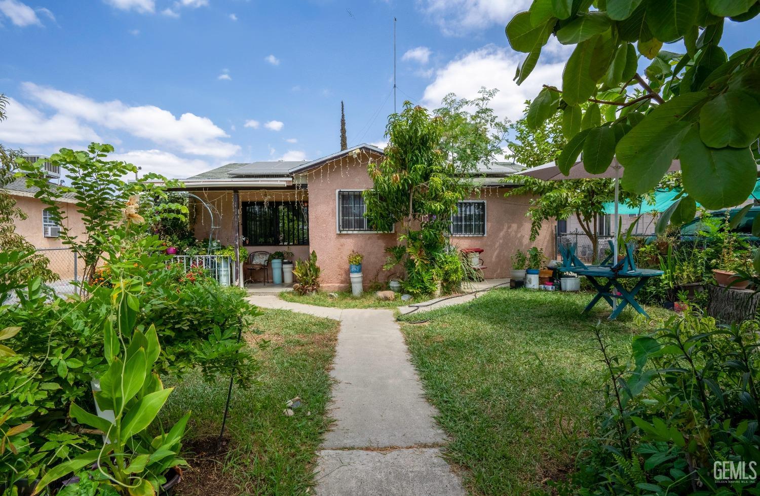 Undisclosed Address Bakersfield, CA 93305 - Photo 3 of 23 a view of a patio with table and chairs and potted plants