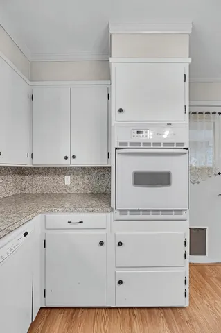a stove top oven sitting inside of a kitchen