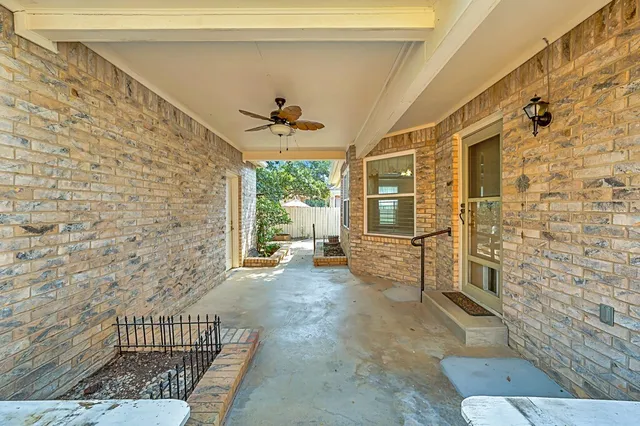 a view of a porch with a table and chairs