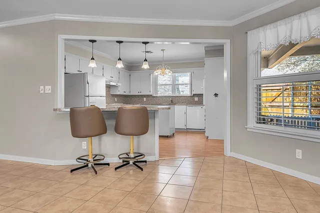 a dining room with furniture and a chandelier