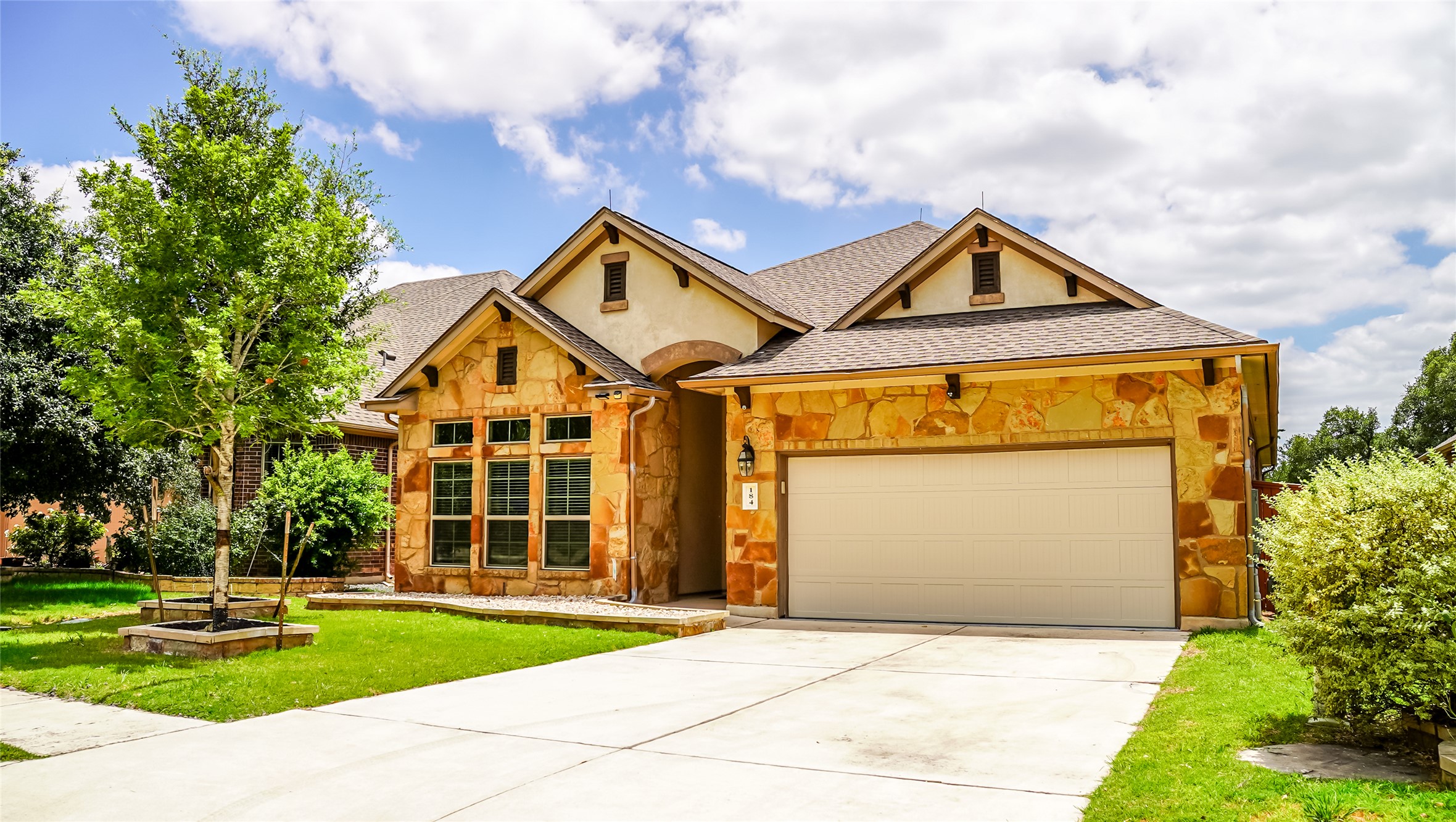 a front view of a house with a yard