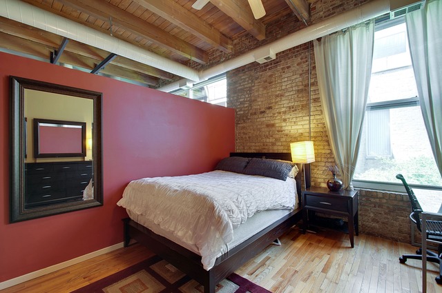 525 North Ada Street, Unit 27 Chicago, IL 60642 - Photo 11 of 18 a bedroom with a bed and wooden floor