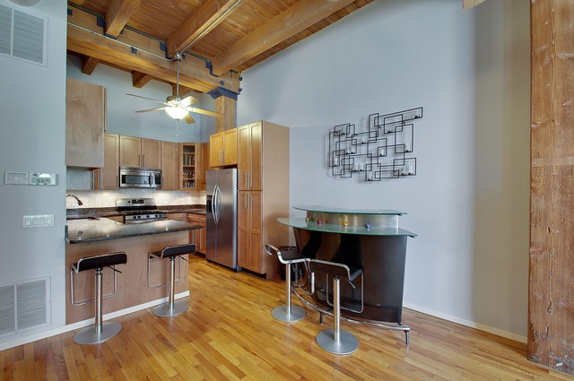 525 North Ada Street, Unit 27 Chicago, IL 60642 - Photo 2 of 18 a kitchen with stainless steel appliances a stove a refrigerator and wooden floor