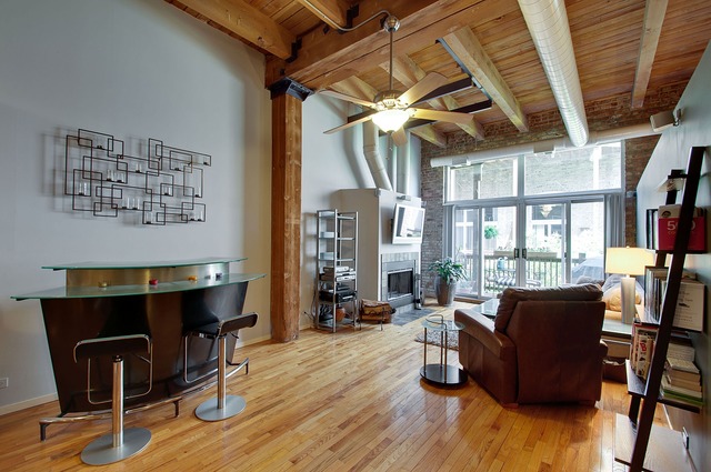 525 North Ada Street, Unit 27 Chicago, IL 60642 - Photo 3 of 18 a living room with furniture and a wooden floor