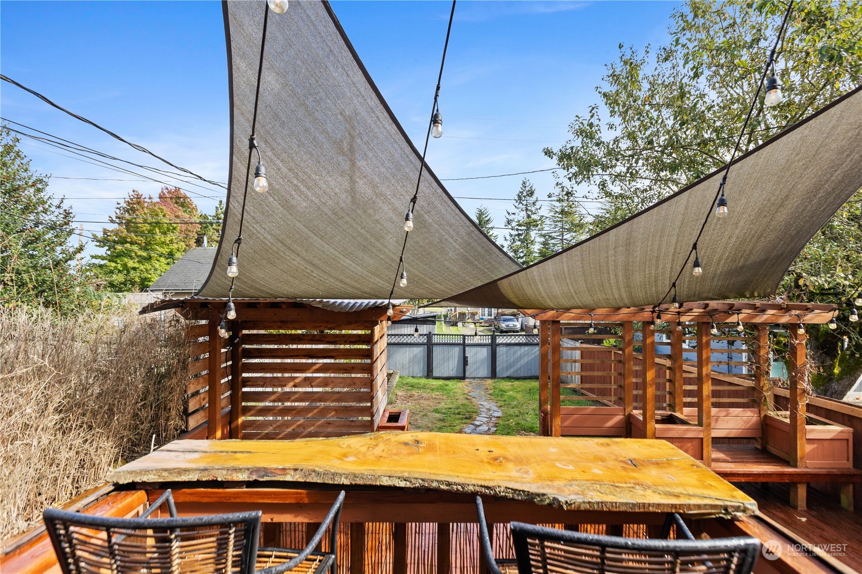 3215 Rockefeller Avenue Everett, WA 98201 - Photo 22 of 31 a view of a backyard with table and chairs with wooden fence
