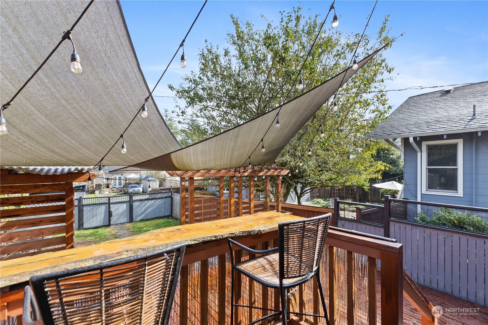 3215 Rockefeller Avenue Everett, WA 98201 - Photo 23 of 31 a view of a patio with table and chairs with wooden floor and fence